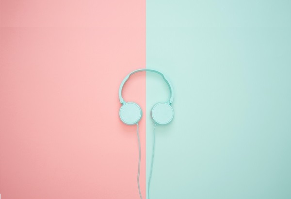 headphones on a pastel-hued-pink-and-blue background