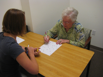 An elderly woman taking a test