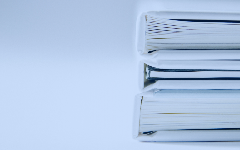 Stack of white books on a white table