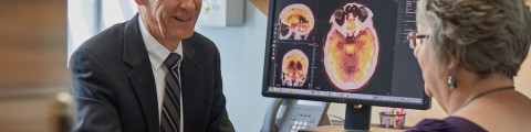 Doctor and patient with screen showing brain scan